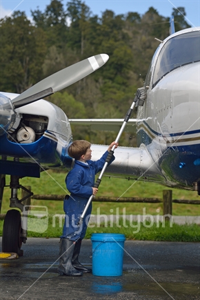 7-year-old boy washing his grandfather's twin engine aeroplane (see also #102612_2462)