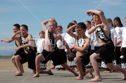 New Zealand has a long history of including aspects of Maori culture in education, as shown by this group of school boys performing the Maori haka at Westport, watched by the girls, around 2008.