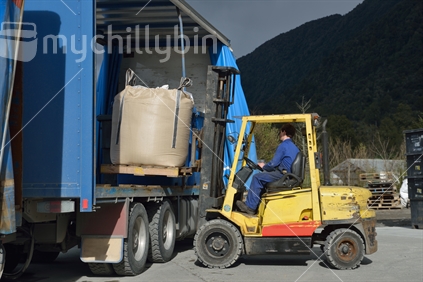 Forklift driver unloads a truck