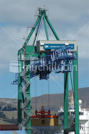 Crane unloading shipping containers at Port of Lyttleton, South Island, New Zealand.