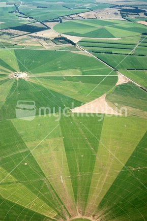 Aerial of dairying farmland irrigated with rotating irrigation arms, Canterbury, South Island