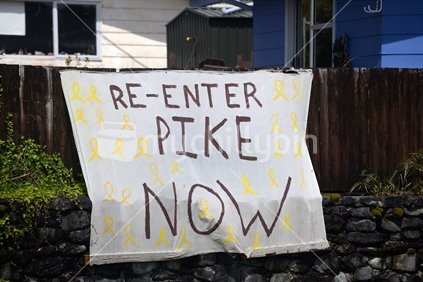 A hand-painted sign calls for the re-entry of the Pike River Mine, days before the government announced that rescue plans were being abandoned. October 29, 2014, Dobson, West Coast