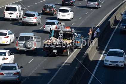 Drivers wait for the police after an accident on one of Auckland's busy motorways