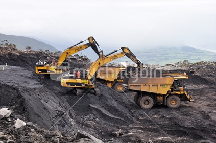 A pair of diggers remove high grade coal from a seam at Stockton open cast coal mine on March 4, 2015 near Westport, New Zealand