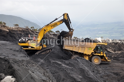 A 40 ton digger removes high grade coal from a seam at Stockton open cast coal mine near Westport, New Zealand