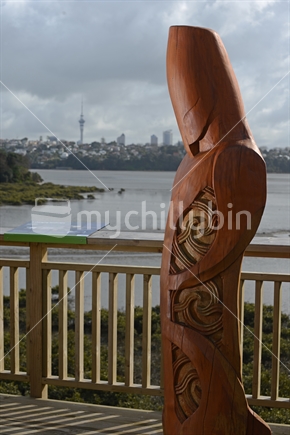 A carving of a Maori pou overlooks the Orakei Basin in Auckland where a Maori village once stood