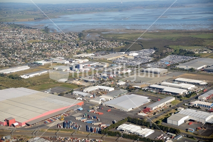 Industrial buildings in South Auckland including the Rail Link and Manukau Harbour.