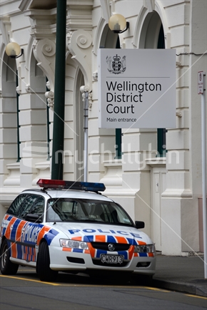A police car waits outside Wellington District Court