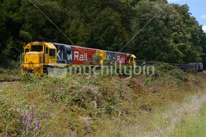A freight train carries a load of gold ore from Reefton, New Zealand