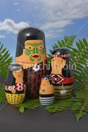 Blended cultures; a family of wooden Maori dolls styled as traditional Russian dolls