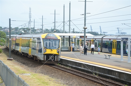 A commuter train stops at a suburban Auckland train station