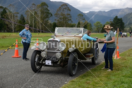 Contestants in a vintage car rally hang out washing in a timed competition. The vehicle is a 1930 Alvis Silver Sports Eagle