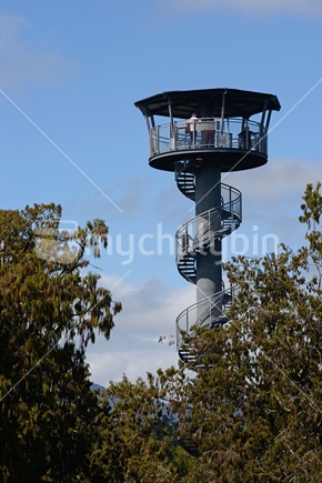Visitors enjoy the view of temperate rainforest and the mountains from the 67m high tower on the Treetops Walk near Hokitika.