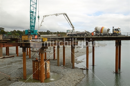 Builders construct a new bridge over the Taramakau River in Westland, New Zealand, September 2017