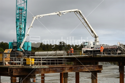 Builders construct a new bridge over the Taramakau River in Westland, New Zealand, September 2017