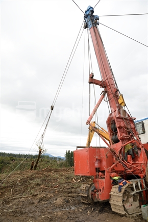 A log hauler machine brings logs to the landing on a forestry site