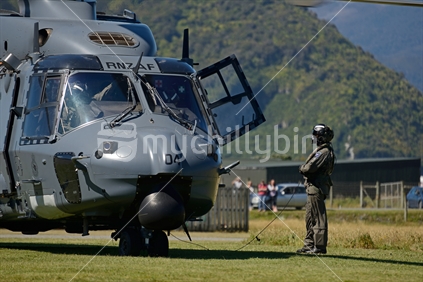 An unidentified pilot makes a pre-flight check on an Air Force NH90 helicopter at an open day in Greymouth run by the New Zealand armed forces. The NH90 was built by NATO Helicopter Industries (NHI) (France).