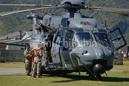 The support crew boards an Air Force NH90 helicopter at an open day in Greymouth run by the New Zealand armed forces. The NH90 was built by NATO Helicopter Industries (NHI) (France).