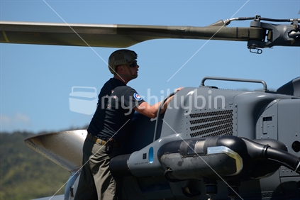 A pilot makes a preflight check on an Air Force NH90 helicopter at an open day in Greymouth run by the New Zealand armed forces. The NH90 was built by NATO Helicopter Industries (NHI) (France).