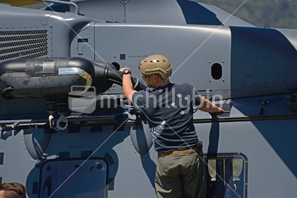 A pilot makes a preflight check on an Air Force NH90 helicopter at an open day in Greymouth run by the New Zealand armed forces. The NH90 was built by NATO Helicopter Industries (NHI) (France).