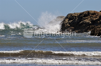 Incoming waves invade Constant Bay on the West Coast of New Zealand