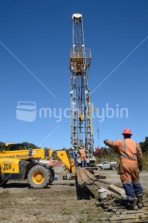 DOBSON, NEW ZEALAND, OCTOBER 13, 2018: Engineers feed the drill string down an old gas well in preparation for capping the well.