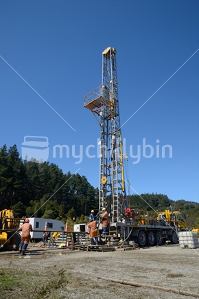 DOBSON, NEW ZEALAND, OCTOBER 13, 2018: Engineers feed the drill string down an old gas well in preparation for capping the well.