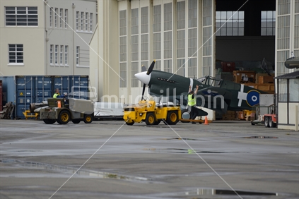 CHRISTCURCH, NEW ZEALAND, DECEMBER 12, 2018: Engineers at the Air Force Museum shift a 1941 Kittyhawk to another hangar for safekeeping.