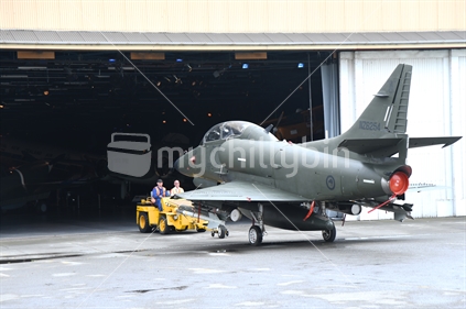 Maintenance crew shift an historic Skyhawk fighter jet at the Air Force Museum in Christchurch, New Zealand