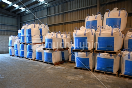 Several cubic metre bags of bulk fertiliser await shipment at a factory.