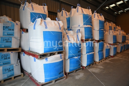 Several cubic metre bags of bulk fertiliser await shipment at a factory.