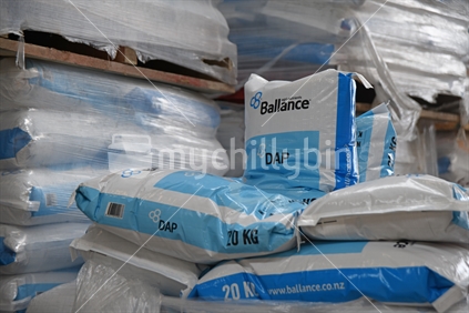 Several 20 kg bags of Balance brand fertiliser await shipment at a factory.