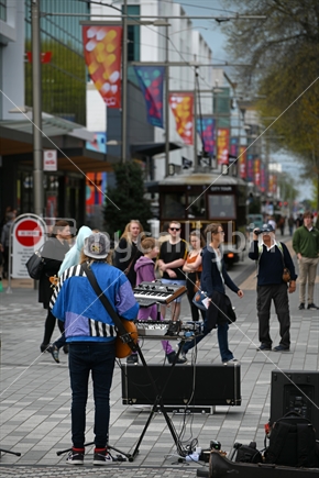 CHRISTCHURCH, NEW ZEALAND, OCTOBER 12, 2019: Musician Reuben Stone entertains a crowd of tourists and spectators near the Christchurch Bridge of Remembrance
