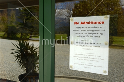 Signage shows that an essential food processing business has restricted access during the Covid 19 lockdown in New Zealand, March 2020