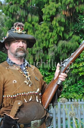 Pioneer character with black powder rifle at Shantytown, Westland