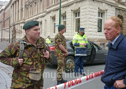 Soldiers speak to members of the public as they patrol the CBD red zone after the September 2010 earthquake in Christchurch
