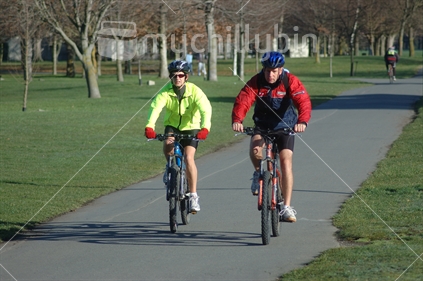 A couple cycling in Hagley Park, Christchurch in the years before the 2010 an 2011 earthquakes.