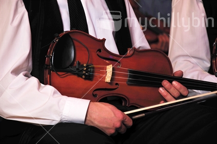 Violinist waiting to play his orchestral part in concert