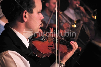 Violinists performing in live concert.