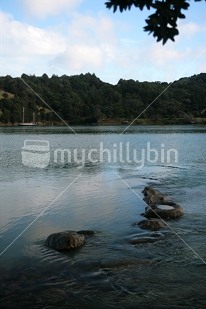 Tidal ripples form as water flows over rocks, Wenderholm, New Zealand. 