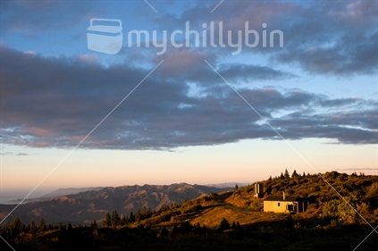 Mt Fyffe hut and Kaikoura's inland ranges take on the glow of a rising sun.
