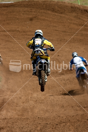 Racing motocross rider in midair