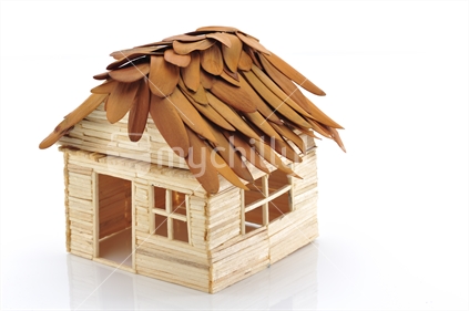 Matchstick house with genuine Kauri leaf roofing.