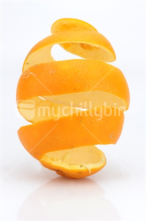 New Zealand orange peel in a spiral shape, isolated on white.
