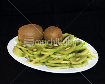 Sliced kiwifruit on a plate.
