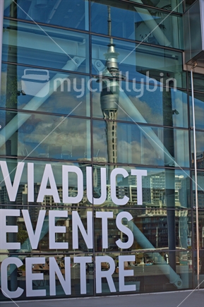 Sky Tower and Auckland CBD being reflected in the glass facade of Viaduct Events Centre
