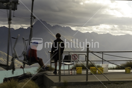 Queenstown chair lift worker, and couple off loading 