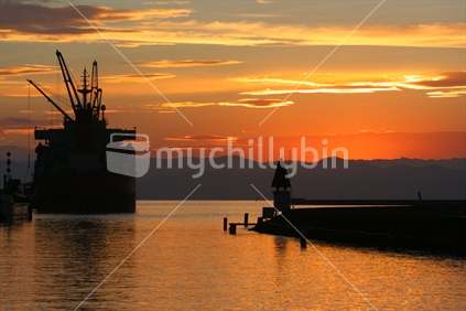 Silhouette of ship berthed in the port of Gisborne, New Zealand.
