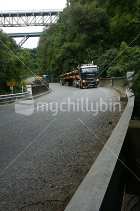 Trucks moving through Matahourua Gorge, SH2 before traffic was diverted to the new overhead route.