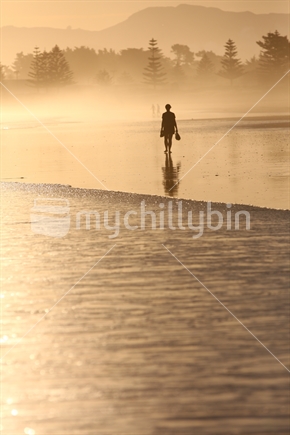 Woman taking a stroll along a Gisborne beach